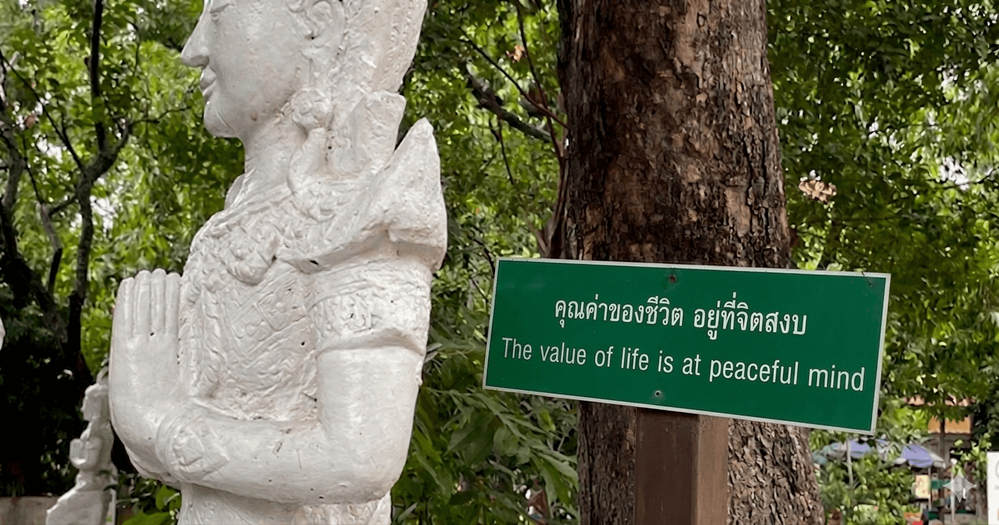 A picture of a statue of Krishna with a sign that reads The value of life is at peaceful mind